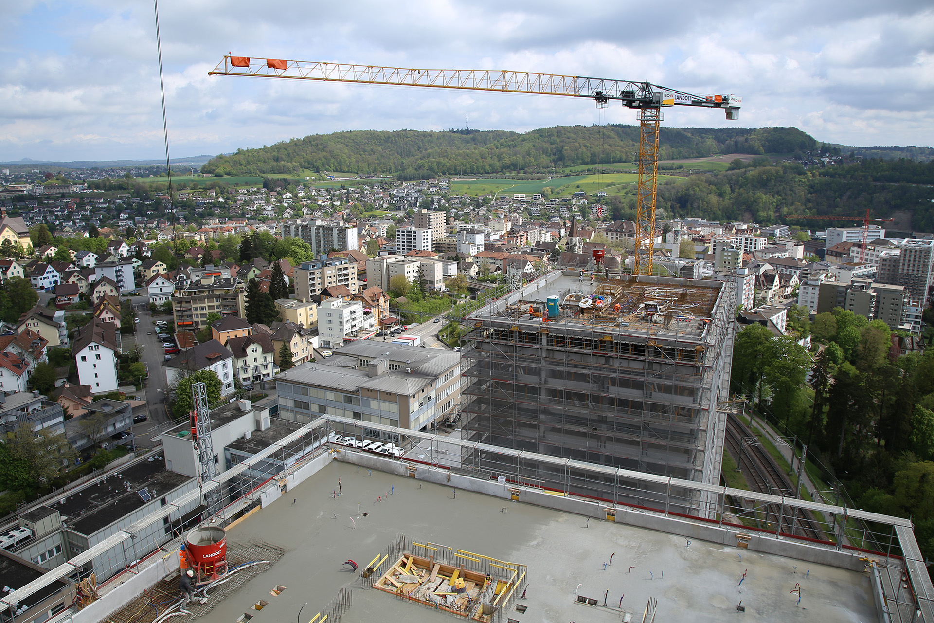 Aerial view of a building site consisting of two buildings which size is elevated in storeys