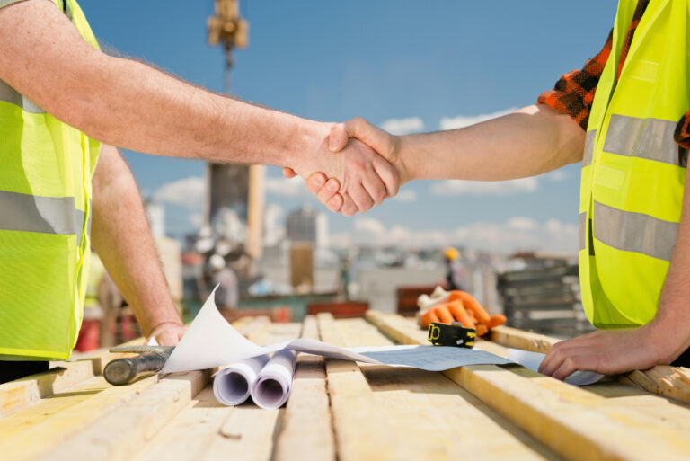 Hand shake on a consutruction site taken closely between two building professionals